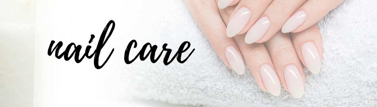 Freshly manicured almond nails resting on a white towel